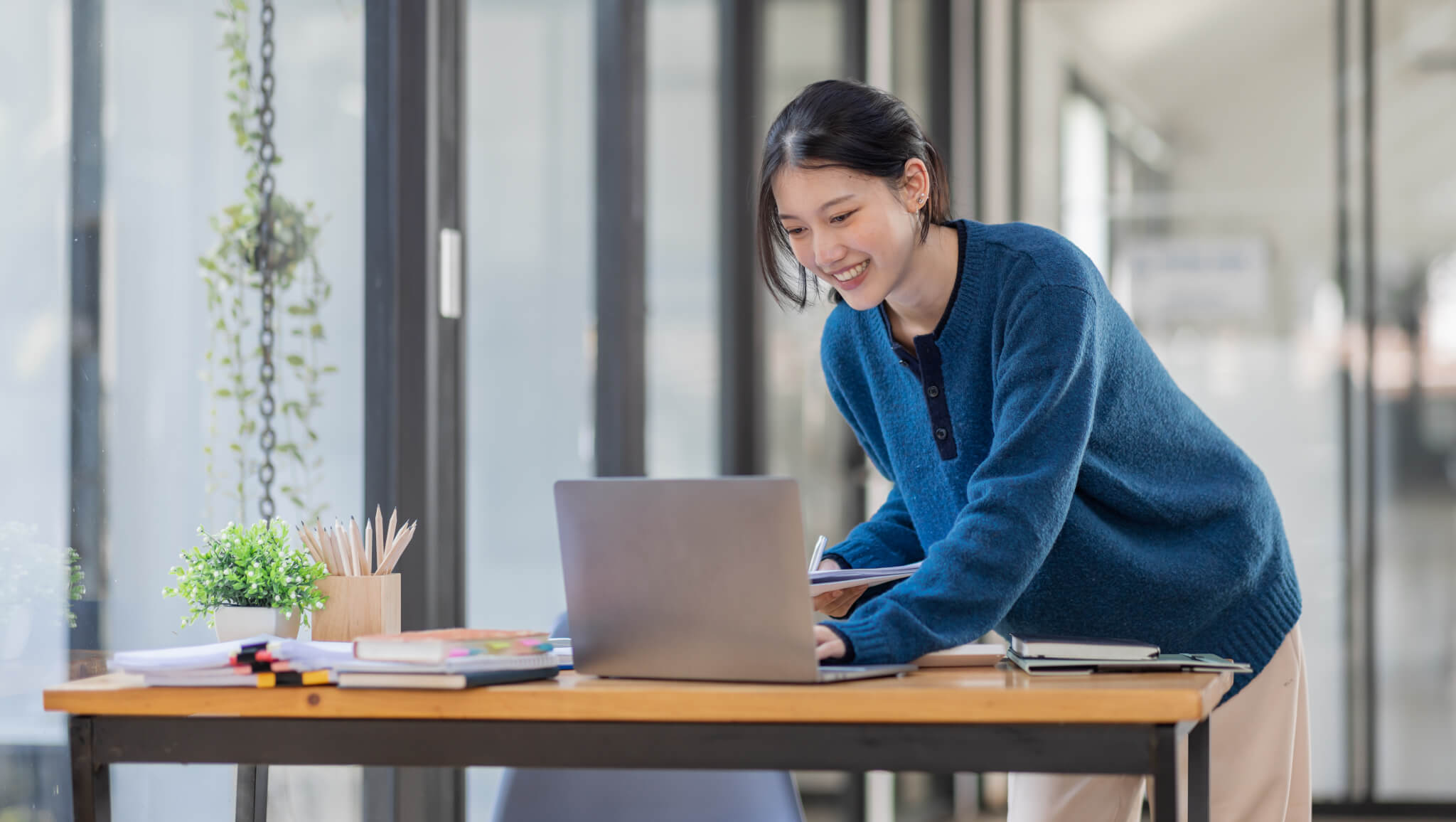 business consulting company's asian-woman-using-laptop-computer-and-working-at-office-with-calculator-document-on-desk.jpg
